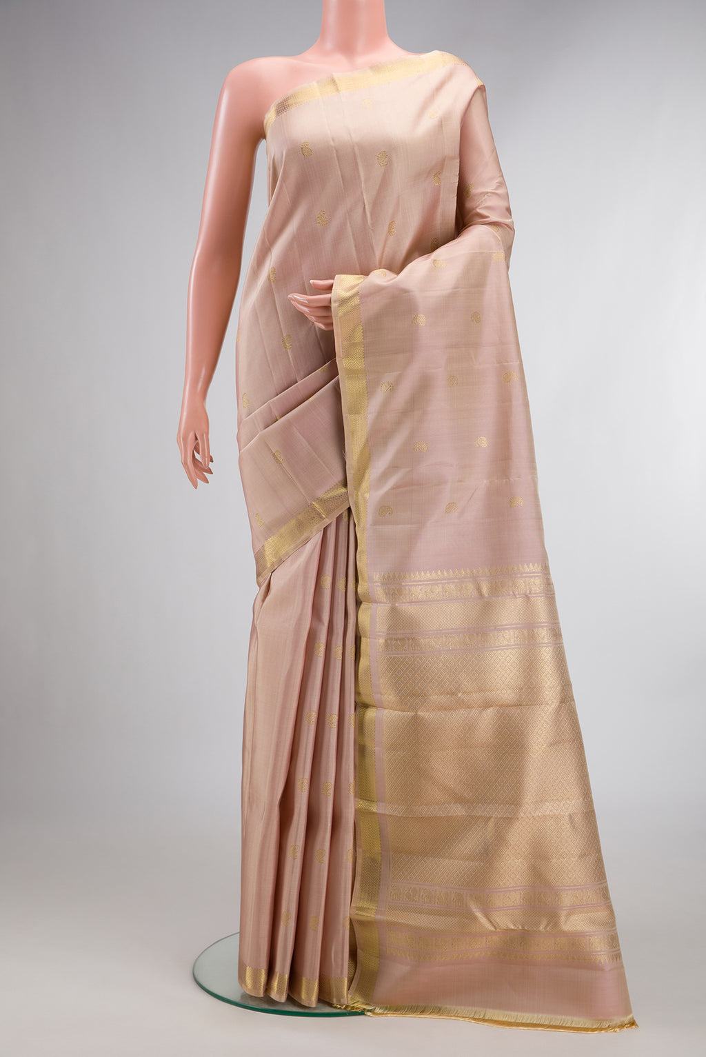 Pure Silk Sandal Kanchipuram Saree with Zari Butta on the body and Zari Border.  displayed on a mannequin