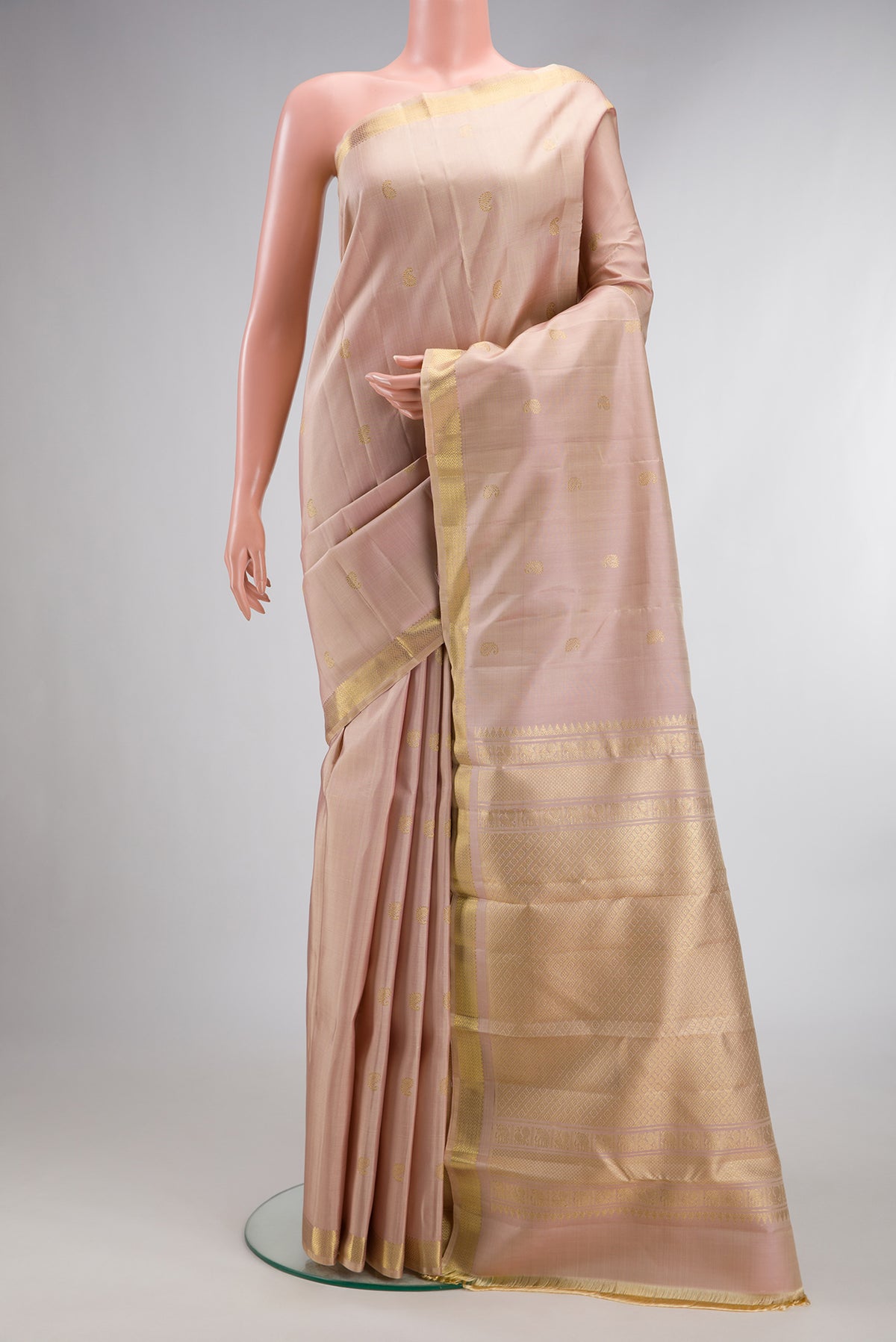 Pure Silk Sandal Kanchipuram Saree with Zari Butta on the body and Zari Border.  displayed on a mannequin