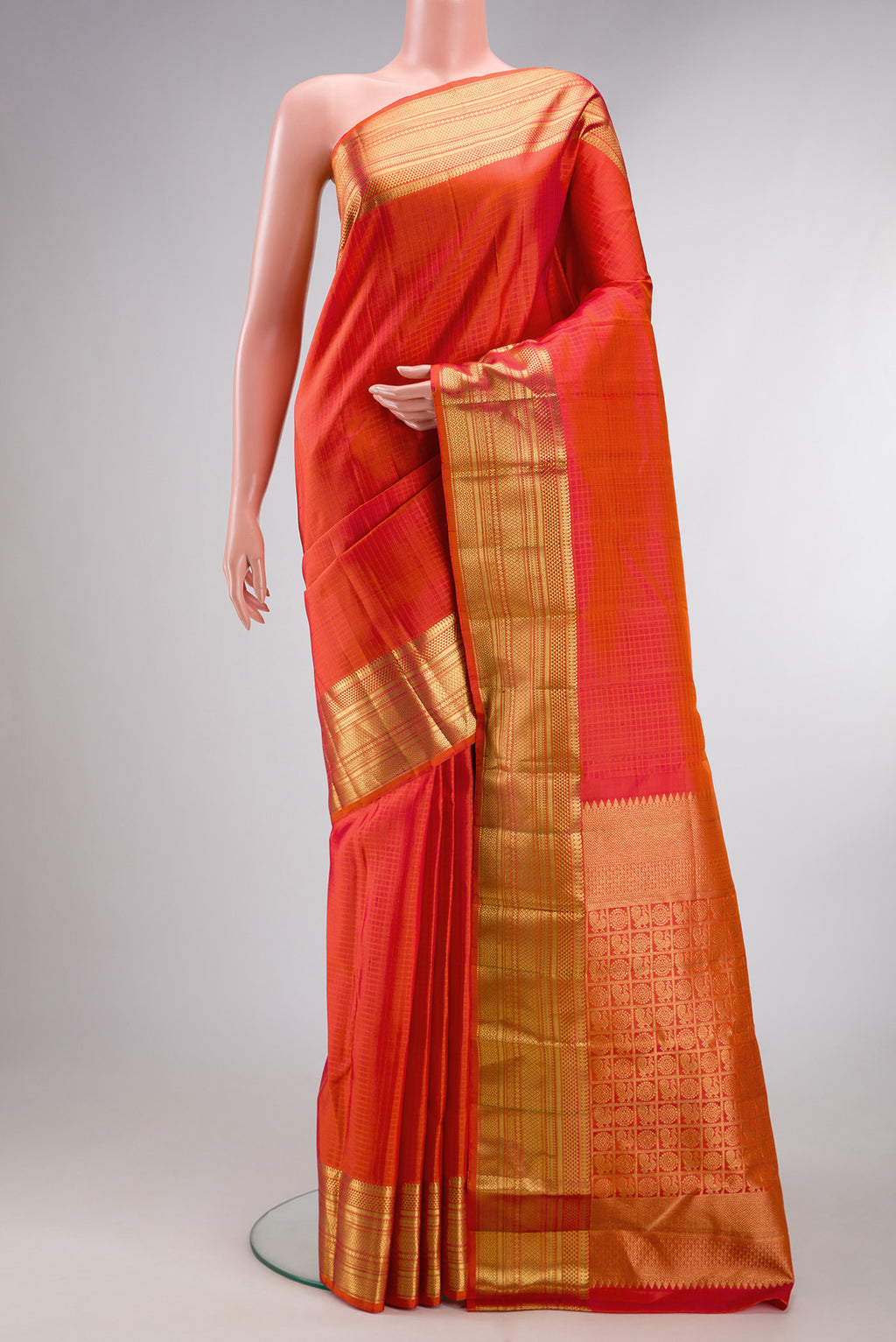 Pure Silk Orange Dual Tone Kanchipuram Saree with Checked design on the body and Zari Border.  displayed on a mannequin