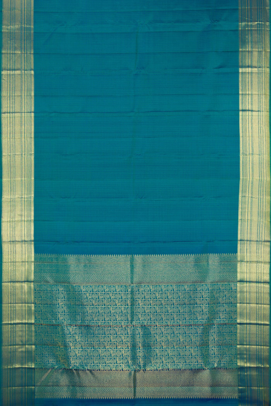 Flat view of Pure Silk Peacock Blue Kanchipuram Saree with Checked design on the body and Zari Border. 