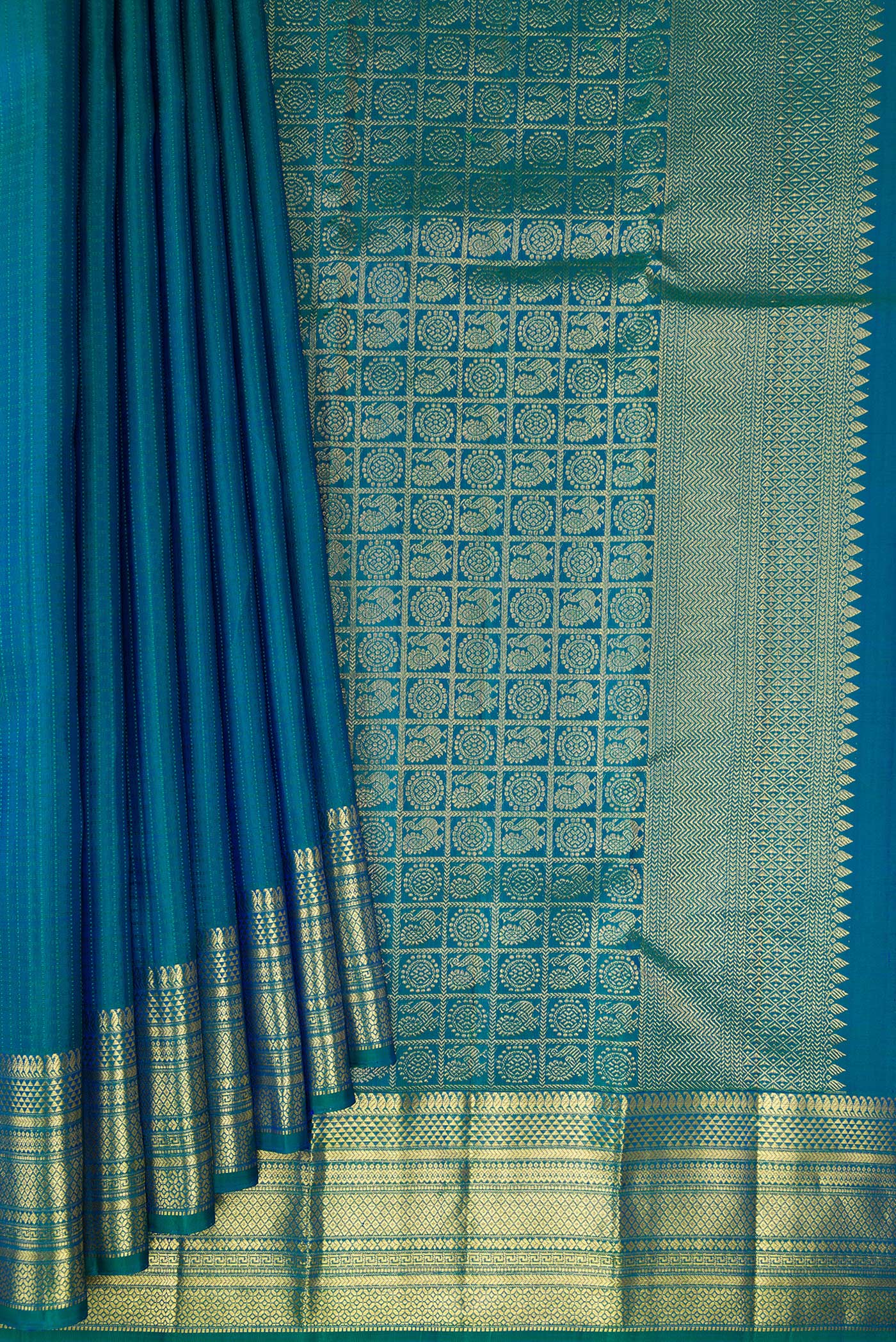 Pleats and pallu of Pure Silk Peacock Blue Kanchipuram Saree with Checked design on the body and Zari Border. 