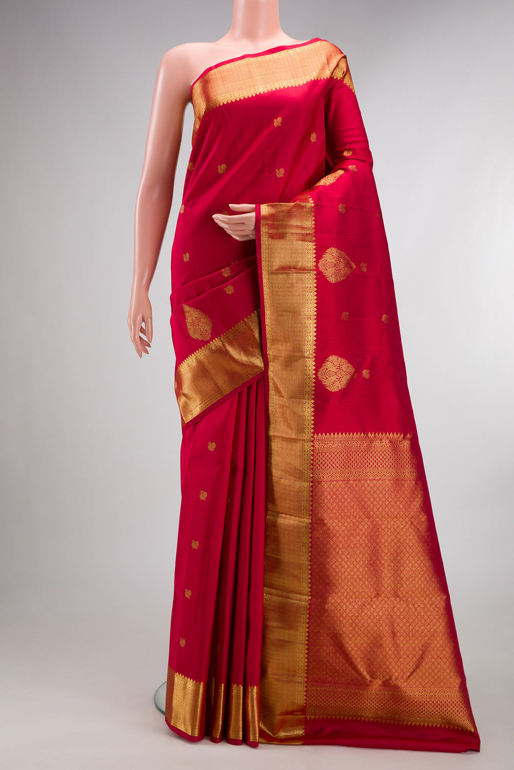 Pure Silk Red Kanchipuram Saree with Zari Butta on the body and Fancy Border.  displayed on a mannequin