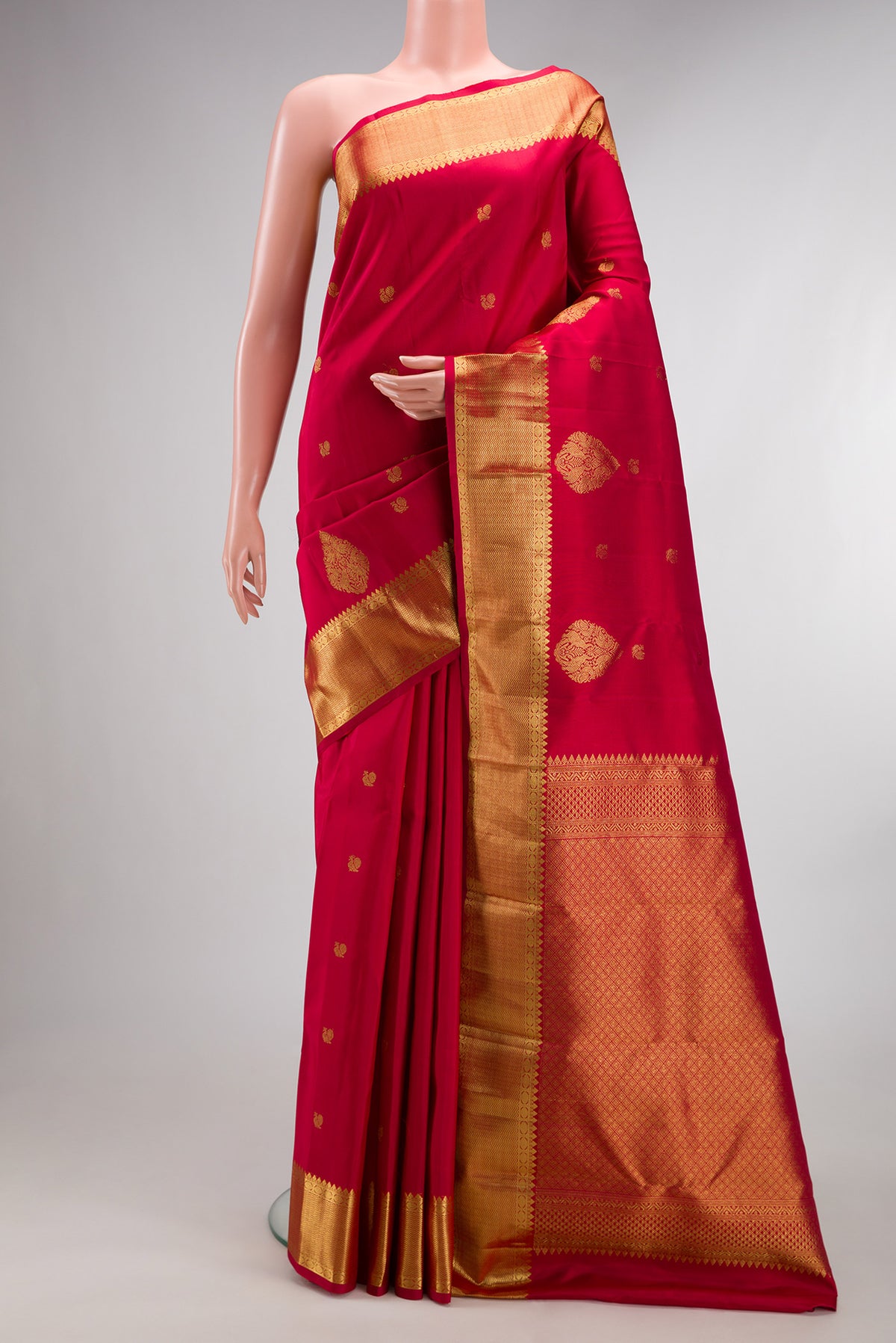 Pure Silk Red Kanchipuram Saree with Zari Butta on the body and Fancy Border.  displayed on a mannequin