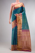 Pure Silk Peacock Blue Dual Tone Kanchipuram Saree with Stripes on the body and Zari Border.  displayed on a mannequin