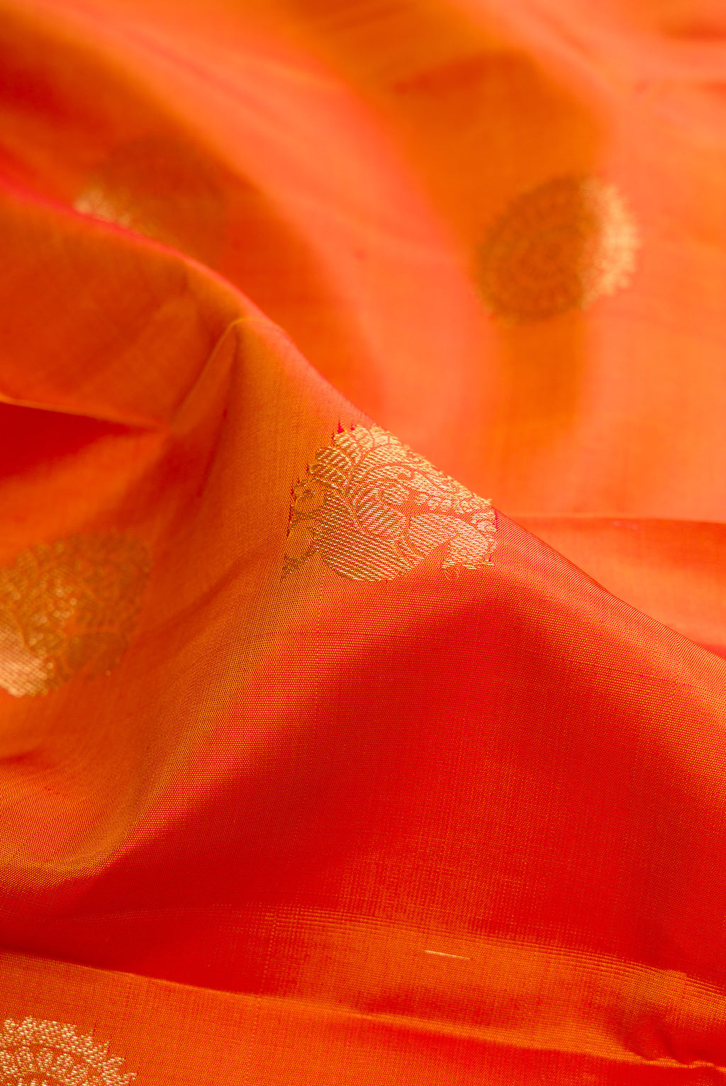 Close up of Pure Silk Mustard Kanchipuram Saree with Zari Butta on the body and Zari Border.  displaying folds