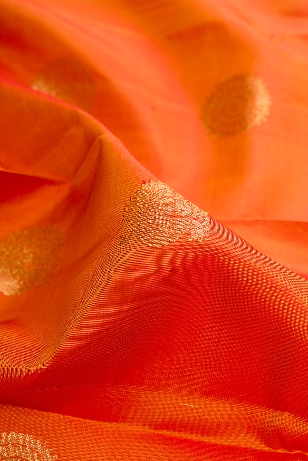 Close up of Pure Silk Mustard Kanchipuram Saree with Zari Butta on the body and Zari Border.  displaying folds