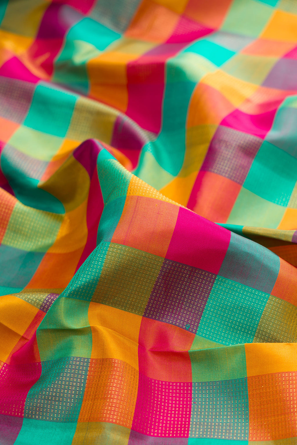 Close up of Pure Silk Multi Color Kanchipuram Saree with Checked design on the body and Zari Border.  displaying folds