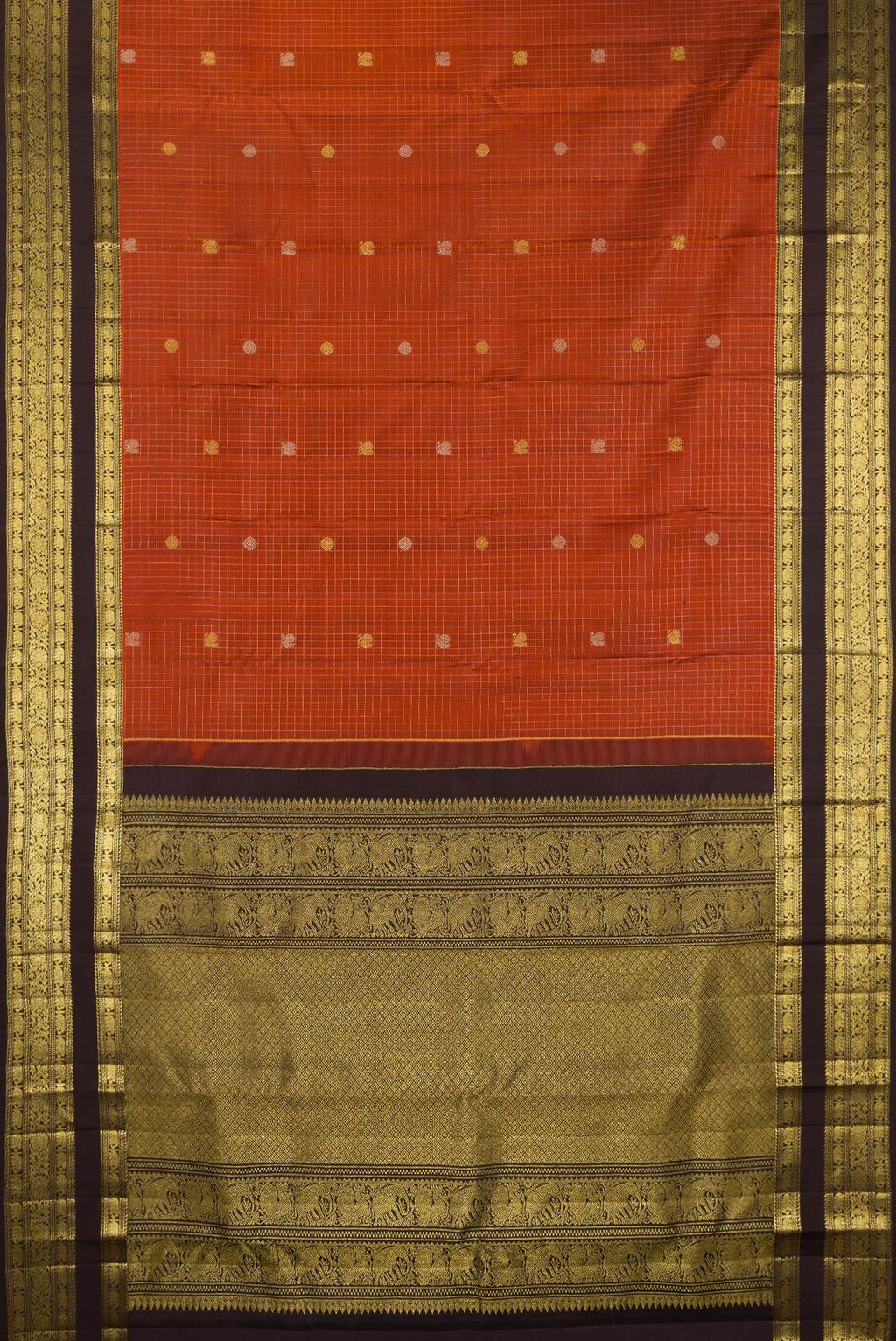 Flat view of Pure Silk Rust Kanchipuram Saree with Checked design on the body and Zari Border. 
