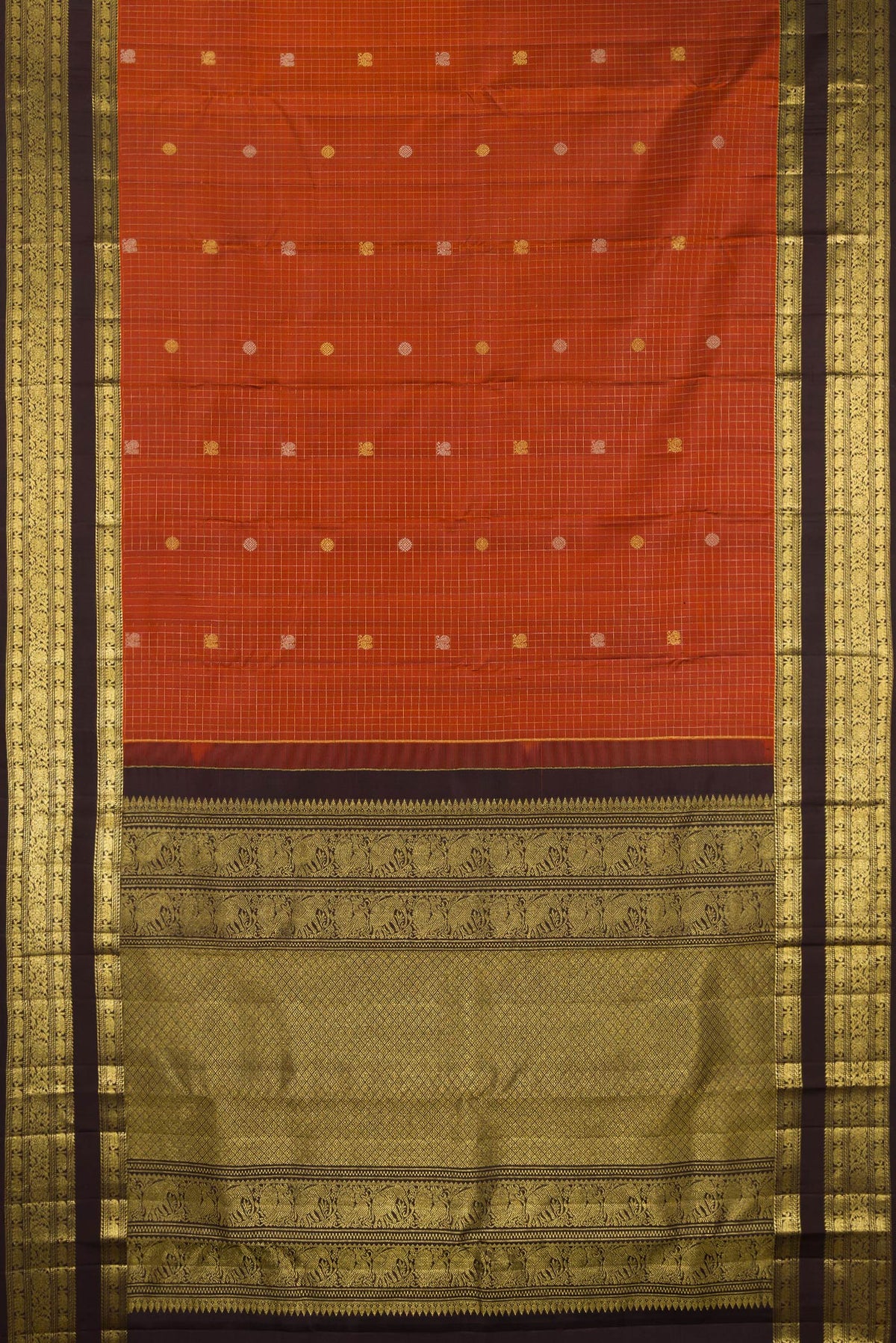 Flat view of Pure Silk Rust Kanchipuram Saree with Checked design on the body and Zari Border. 