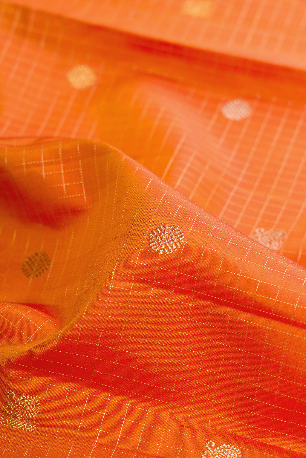 Close up of Pure Silk Mustard Kanchipuram Saree with Checked design on the body and Zari Border.  displaying folds