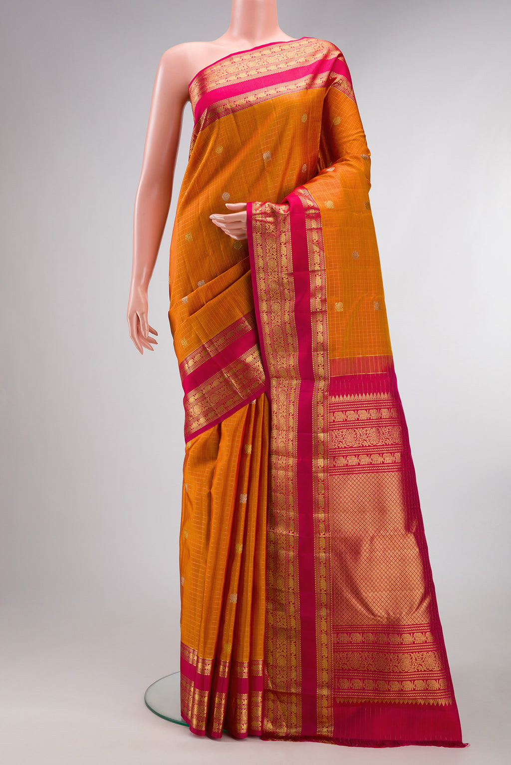 Pure Silk Mustard Kanchipuram Saree with Checked design on the body and Zari Border.  displayed on a mannequin