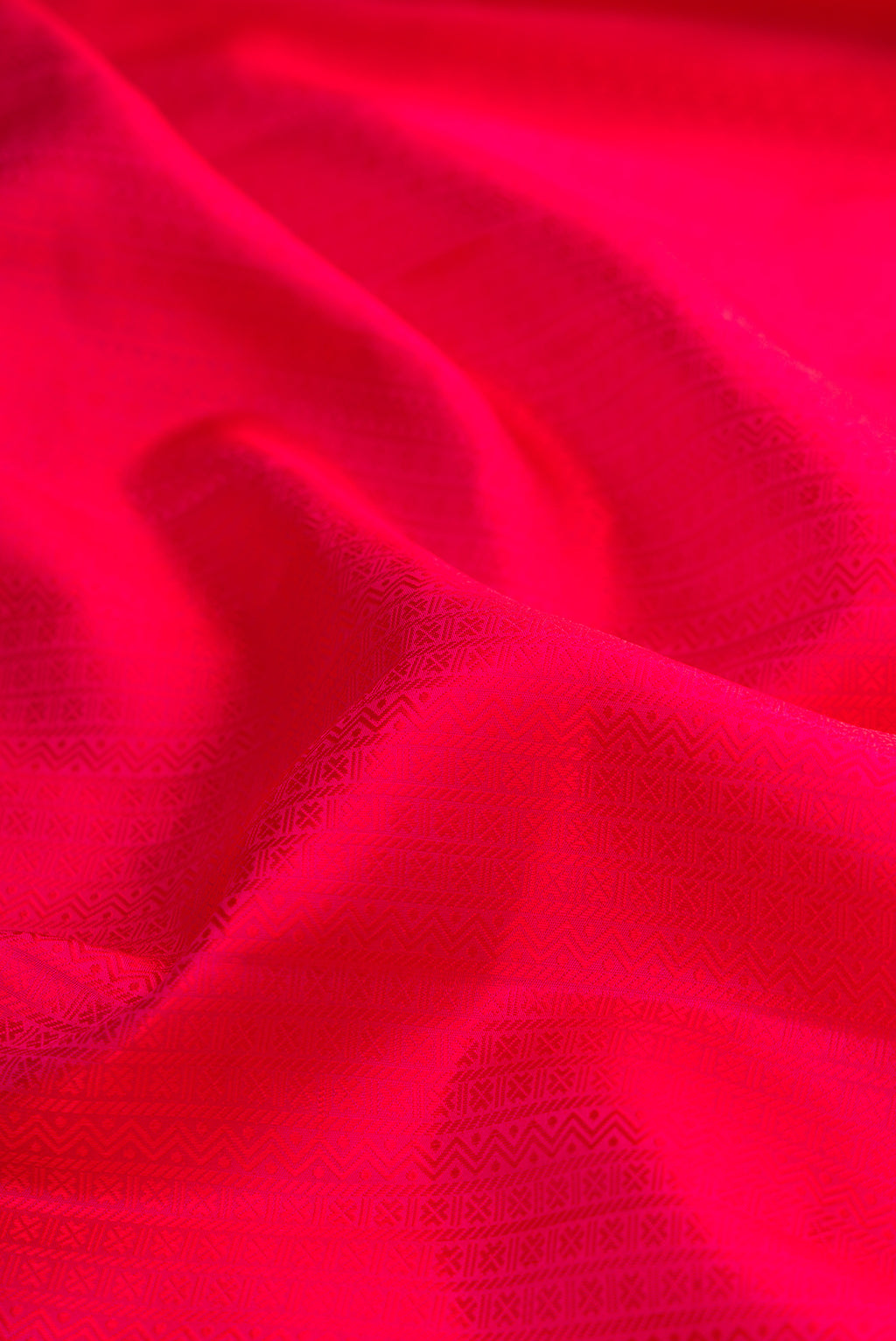 Close up of Pure Silk Dark Pink Kanjivaram Saree with Jacquard design on the body and Zari Border.  displaying folds
