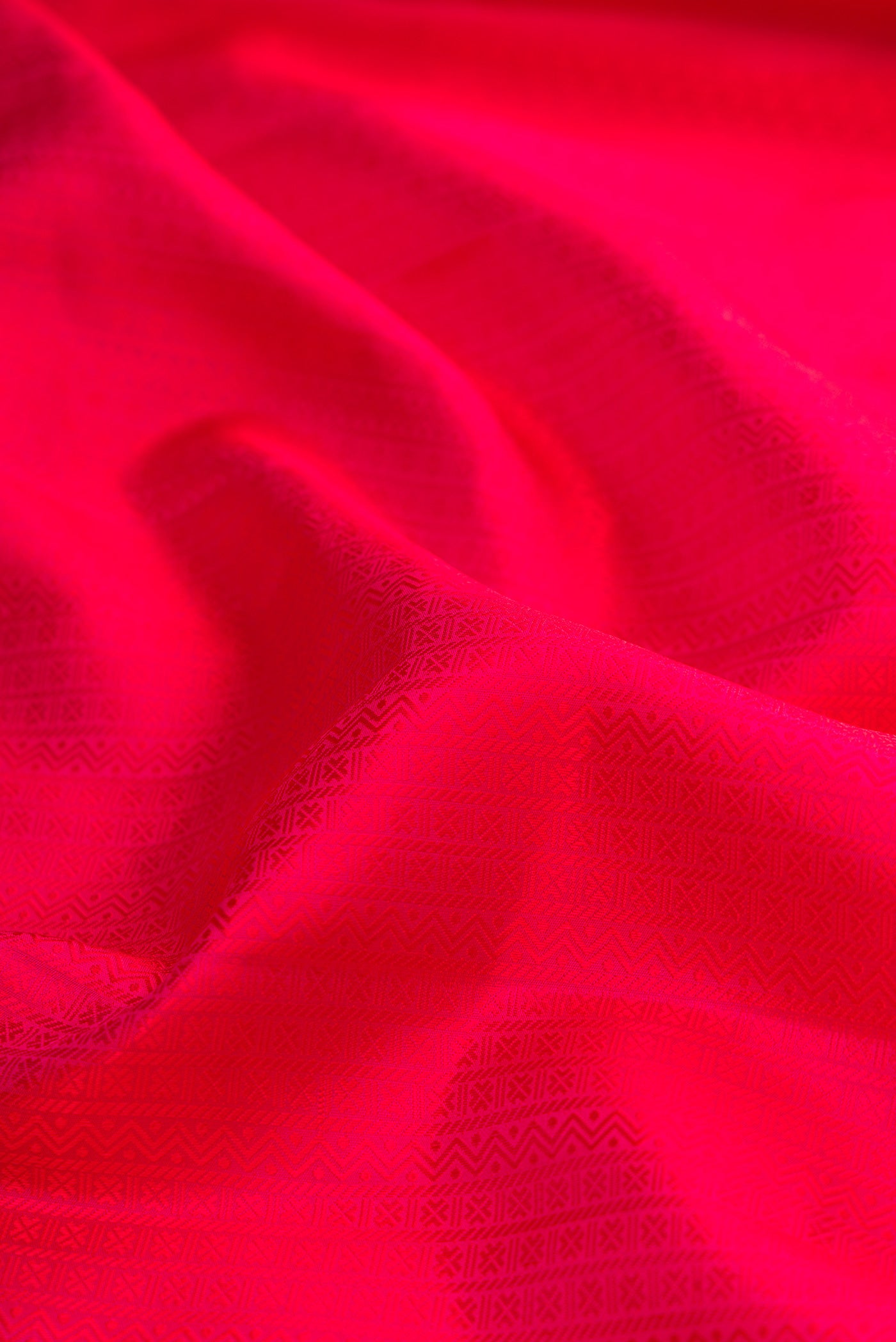 Close up of Pure Silk Dark Pink Kanjivaram Saree with Jacquard design on the body and Zari Border.  displaying folds