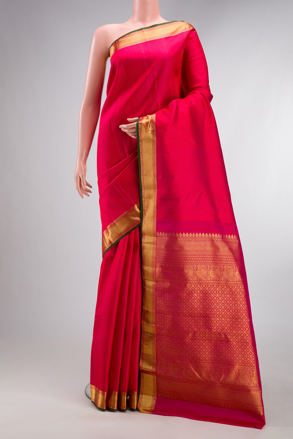 Pure Silk Dark Pink Kanjivaram Saree with Jacquard design on the body and Zari Border.  displayed on a mannequin