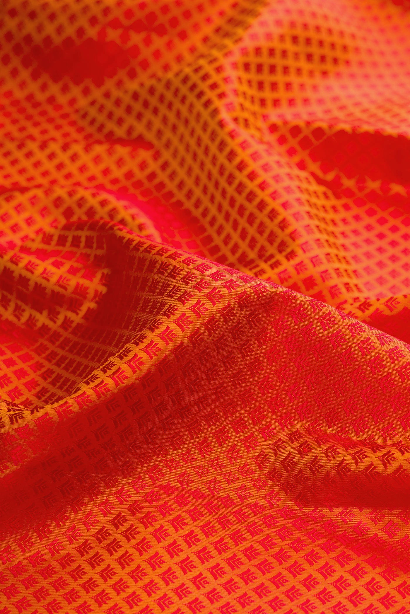 Close up of Pure Silk Orange Kanjivaram Saree with Jacquard design on the body and Zari Border.  displaying folds