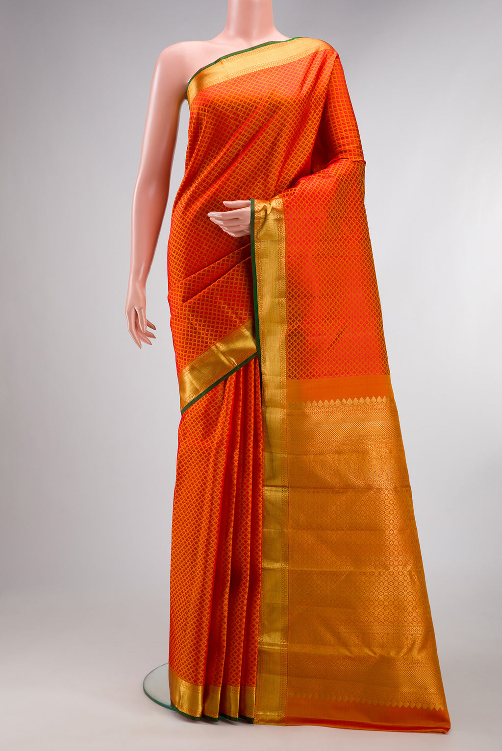 Pure Silk Orange Kanjivaram Saree with Jacquard design on the body and Zari Border.  displayed on a mannequin