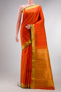 Pure Silk Orange Kanjivaram Saree with Jacquard design on the body and Zari Border.  displayed on a mannequin