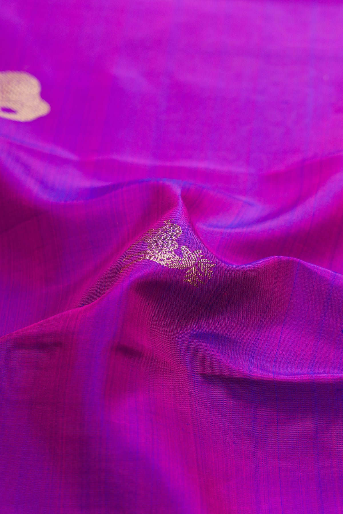 Close up of Pure Silk Purple Kanchipuram Saree with Zari Butta on the body and Zari Border.  displaying folds