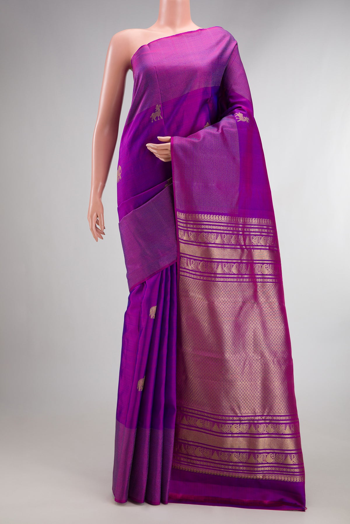 Pure Silk Purple Kanchipuram Saree with Zari Butta on the body and Zari Border.  displayed on a mannequin