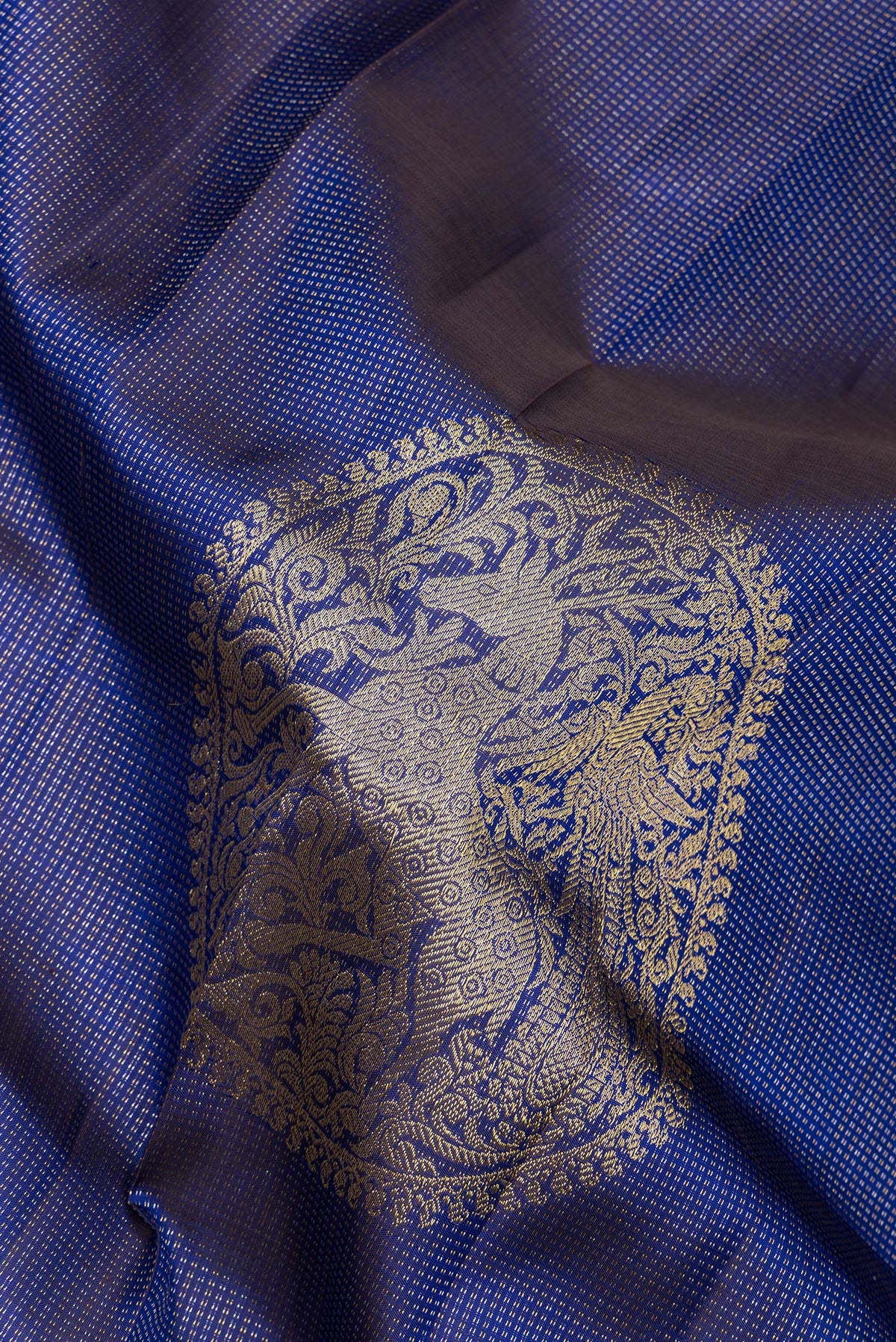 Close up of Pure Silk Royal Blue Kanchipuram Saree with Stripes on the body and Without Border.  displaying folds