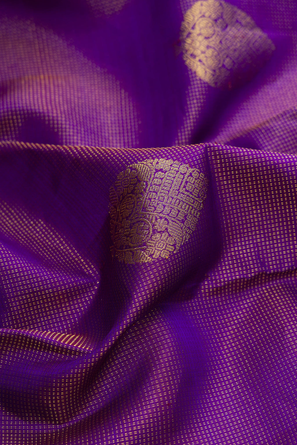 Close up of Pure Silk Purple Kanchipuram Saree with Zari Butta on the body and Zari Border.  displaying folds