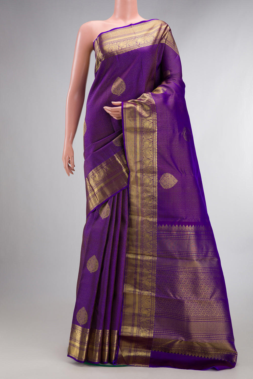Pure Silk Purple Kanchipuram Saree with Zari Butta on the body and Zari Border.  displayed on a mannequin