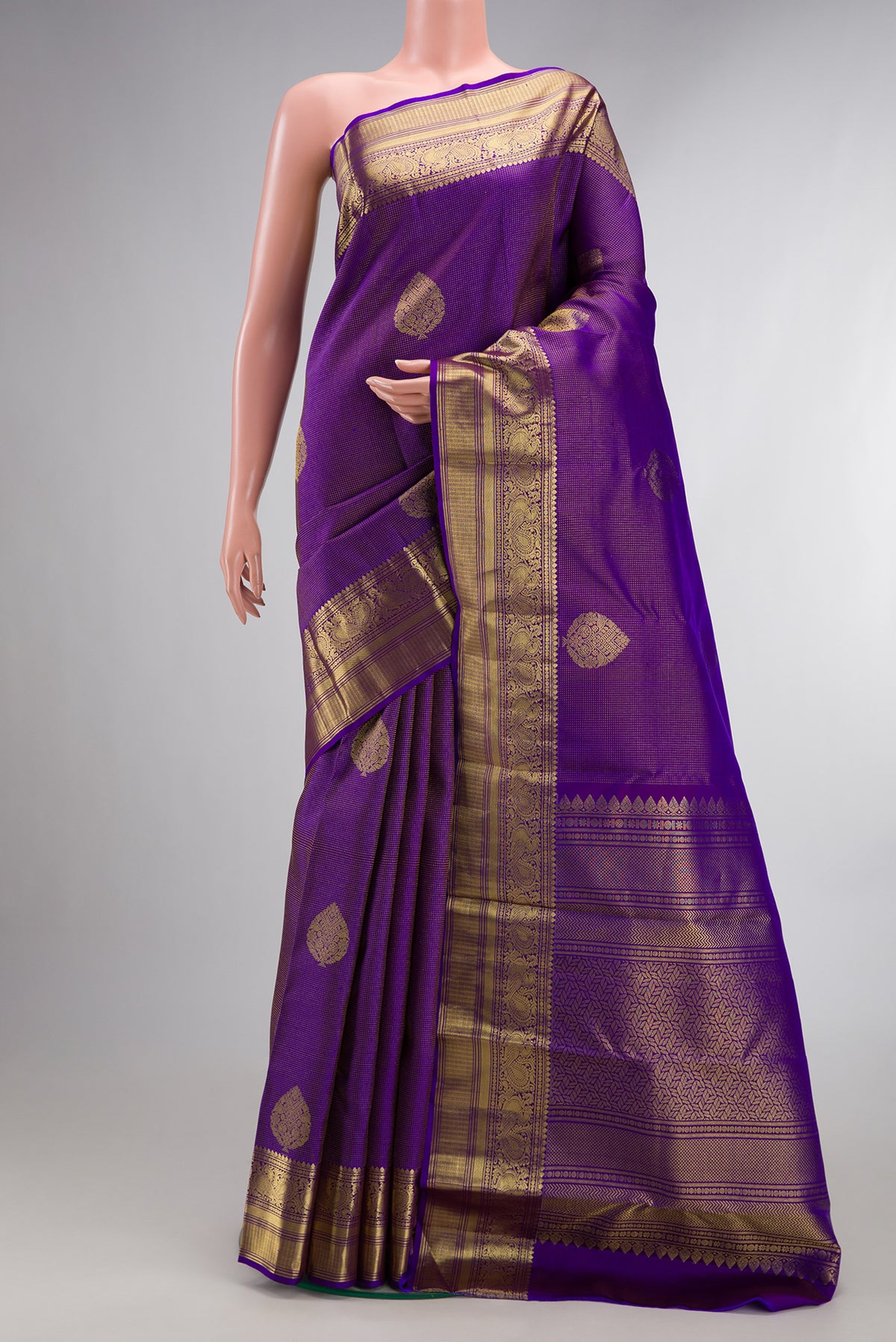 Pure Silk Purple Kanchipuram Saree with Zari Butta on the body and Zari Border.  displayed on a mannequin