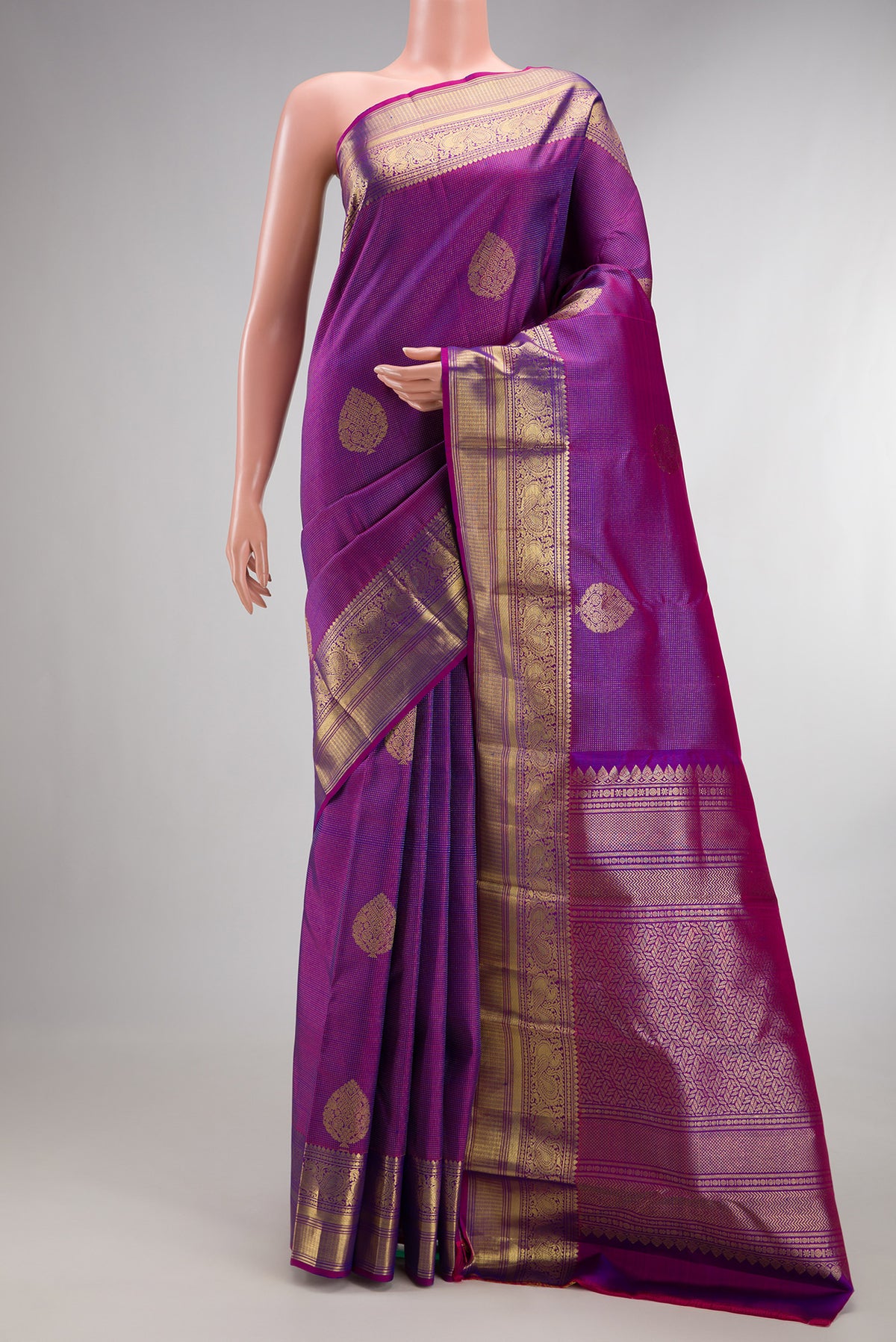 Pure Silk Purple Kanchipuram Saree with Zari Butta on the body and Zari Border.  displayed on a mannequin