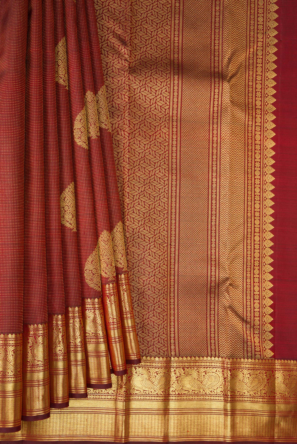 Pleats and pallu of Pure Silk Maroon Kanchipuram Saree with Zari Butta on the body and Zari Border. 