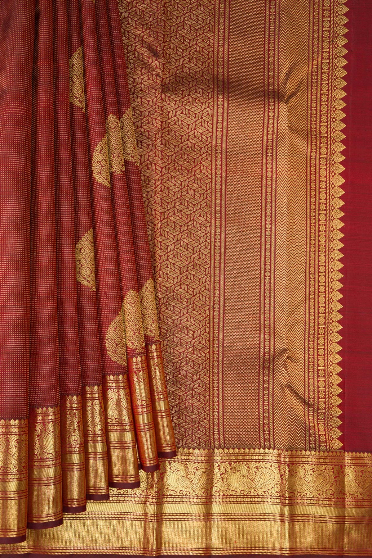 Pleats and pallu of Pure Silk Maroon Kanchipuram Saree with Zari Butta on the body and Zari Border. 