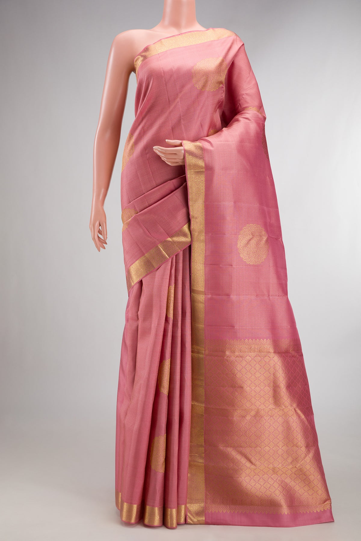 Pure Silk Coral Dual Tone Kanchipuram Saree with Zari Butta on the body and Zari Border.  displayed on a mannequin