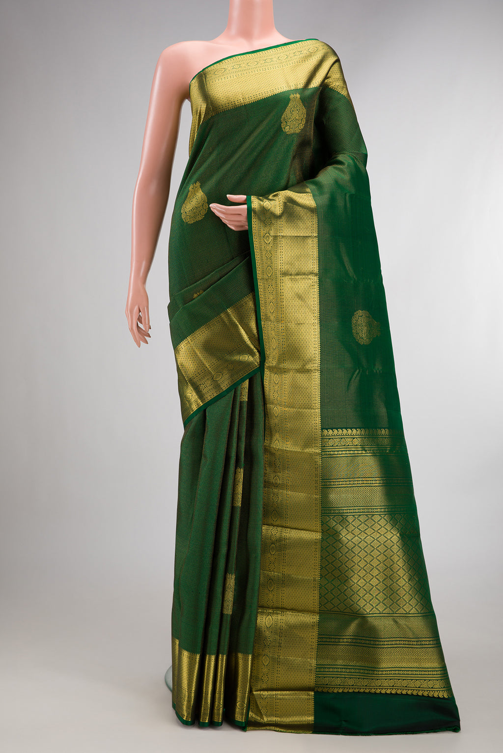 Pure Silk Bottle Green Kanchipuram Saree with Zari Butta on the body and Zari Border.  displayed on a mannequin