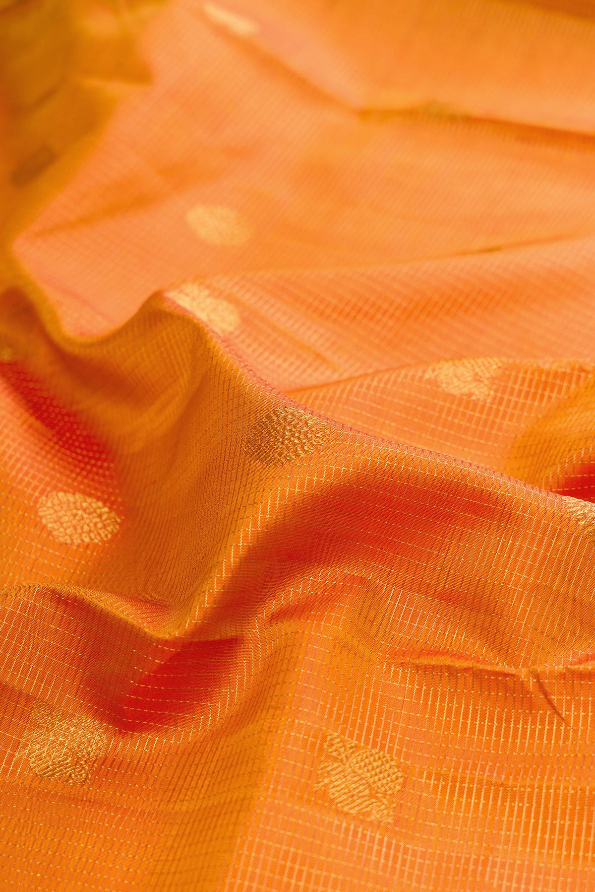 Close up of Pure Silk Mustard Kanjivaram Saree with Checked design on the body and Zari And Thread Border.  displaying folds