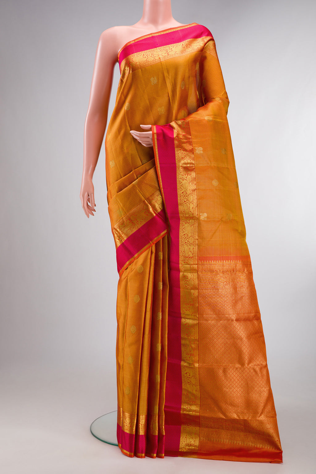 Pure Silk Mustard Kanjivaram Saree with Checked design on the body and Zari And Thread Border.  displayed on a mannequin