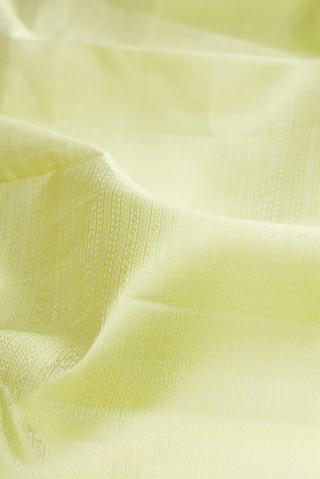 Close up of Pure Silk Pista Green Kanjivaram Saree with Jacquard design on the body and Zari Border.  displaying folds