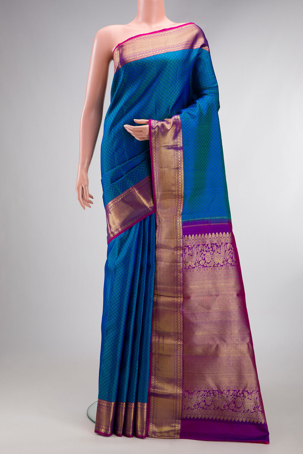 Pure Silk Peacock Blue Dual Tone Kanjivaram Saree with Jacquard design on the body and Zari Border.  displayed on a mannequin