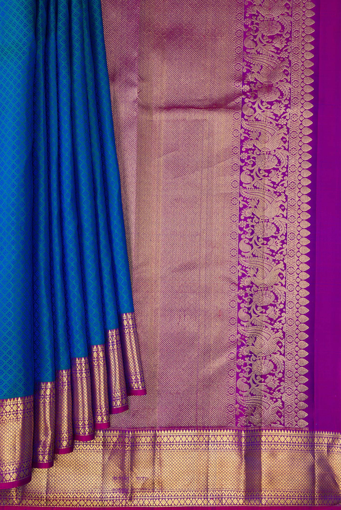 Pleats and pallu of Pure Silk Peacock Blue Dual Tone Kanjivaram Saree with Jacquard design on the body and Zari Border. 