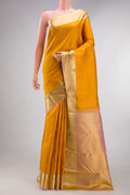 Pure Silk Mustard Kanjivaram Saree with Jacquard design on the body and Zari Border.  displayed on a mannequin