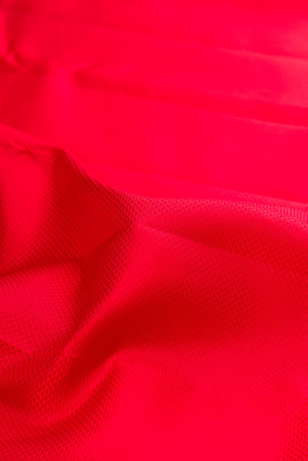 Close up of Pure Silk Red Dual Tone Kanjivaram Saree with Jacquard design on the body and Zari Border.  displaying folds