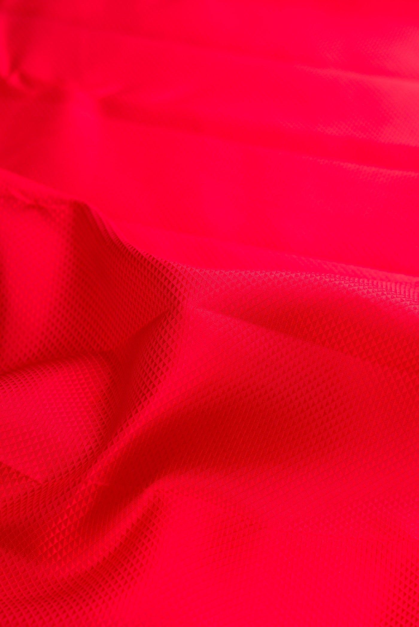 Close up of Pure Silk Red Dual Tone Kanjivaram Saree with Jacquard design on the body and Zari Border.  displaying folds