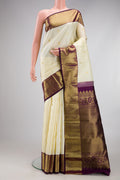 Off White Kanjivaram Silk Saree with Zari Butta on the body and Zari Border.  displayed on a mannequin