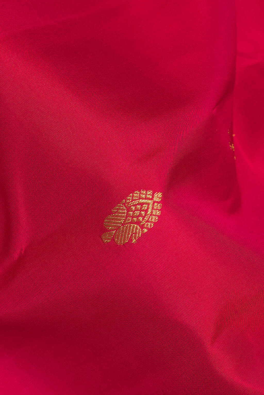 Close up of Pure Silk Red Kanjivaram Saree with Zari Butta on the body and Zari Border.  displaying folds
