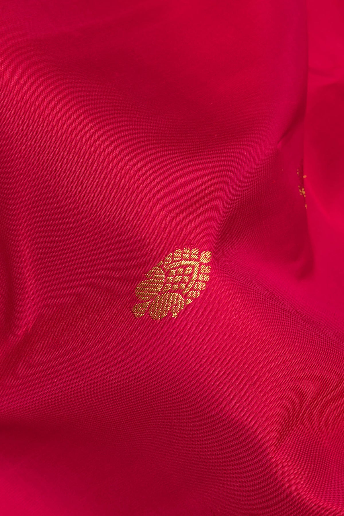 Close up of Pure Silk Red Kanjivaram Saree with Zari Butta on the body and Zari Border.  displaying folds