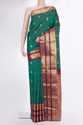 Pure Silk Bottle Green Kanjivaram Saree with Zari Butta on the body and Zari Border.  displayed on a mannequin