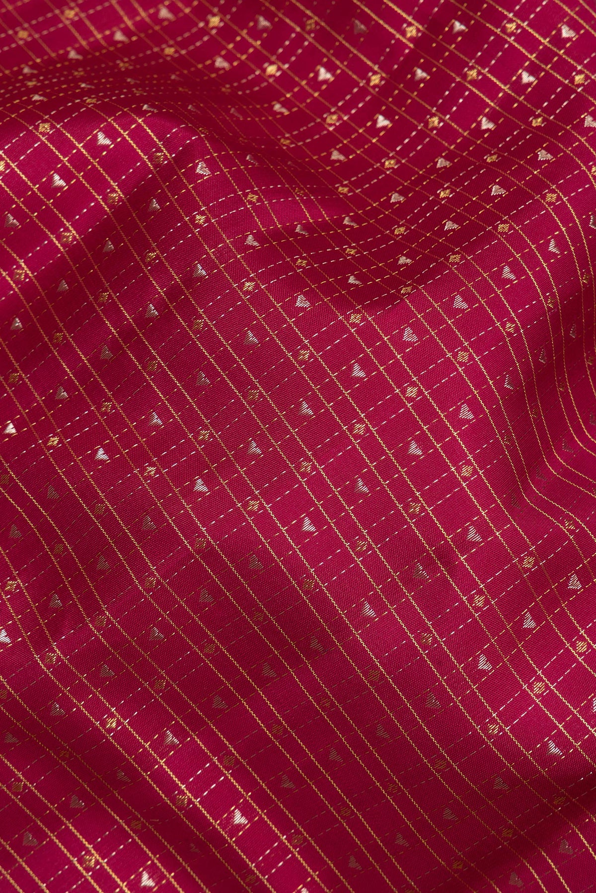 Close up of Pure Silk Deep Red Kanchipuram Saree with Checked design on the body and Zari Border.  displaying folds