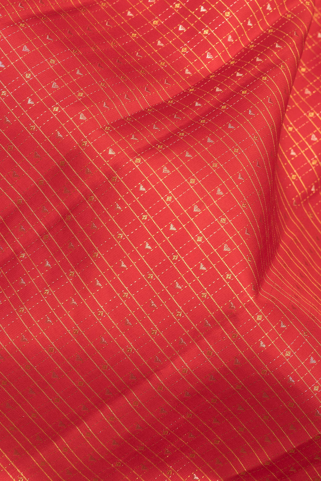 Close up of Pure Silk Orange Kanchipuram Saree with Checked design on the body and Plain Border.  displaying folds