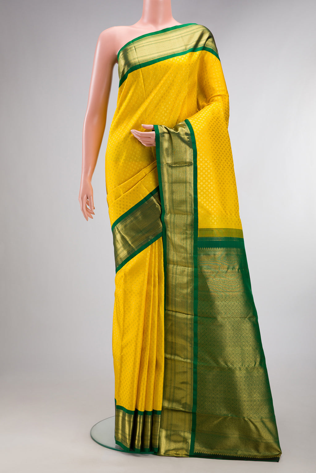 Pure Silk Yellow Kanjivaram Saree with Zari Brocade on the body and Zari Border.  displayed on a mannequin