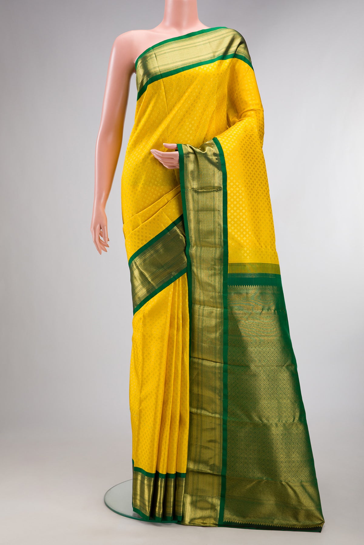 Pure Silk Yellow Kanjivaram Saree with Zari Brocade on the body and Zari Border.  displayed on a mannequin