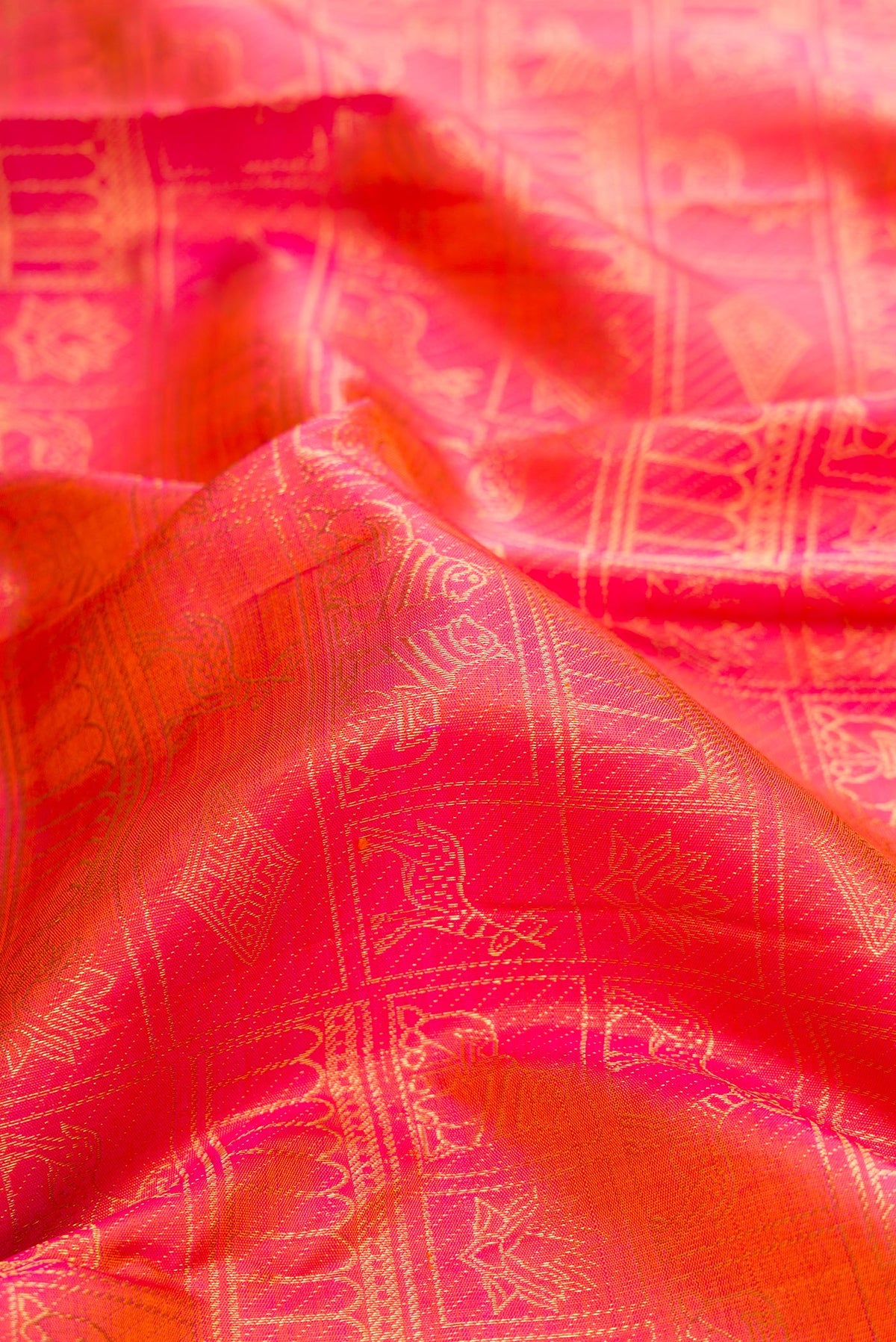 Close up of Pure Silk Pink with Orange Color Kanjivaram Saree with Zari Brocade on the body and Zari Border.  displaying folds