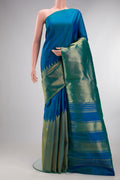Pure Silk Peacock Blue Dual Tone Kanjivaram Saree with Plain Body and Rising Temple Border.  displayed on a mannequin